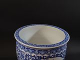 a blue and white cup sitting on a black surface