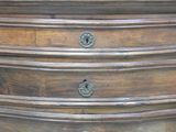 an image of a wooden chest of drawers with knobs