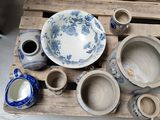 a wooden pallet with a bunch of blue and white pottery on it
