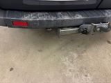 the rear end of a car with a tow bar attached to it ' s bumper