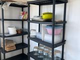 a black shelf with dishes on it in a kitchen