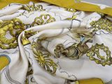 a yellow and white scarf with a picture of a horse on it