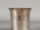 a silver cup that is sitting on a table