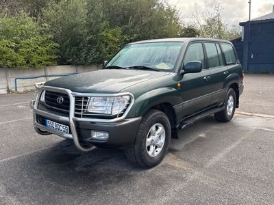 a picture of a green suv parked in a parking lot