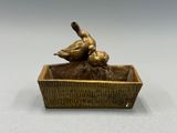 sculpture en bronze représentant deux canards posés dans une jardinière en bois