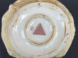 a close up view of a vase with a triangle on it