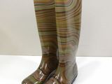 pair of brown rain boots sitting on top of a white table