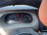 dashboard of a car with a person holding a steering wheel