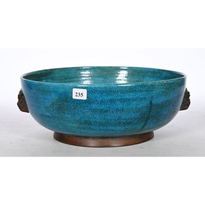 an image of a blue bowl sitting on top of a wooden stand