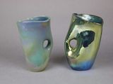 two vases sitting next to each other on a table