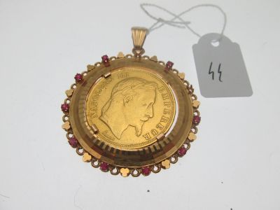 un gros plan d'une pièce d'or posée sur une surface blanche, accompagnée d'une étiquette de prix