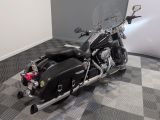a black motorcycle parked in a room with a checkered floor