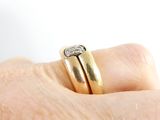a close up of a person ' s hand with a diamond ring on it