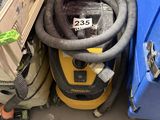 a vacuum that is sitting next to a blue box