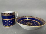 a close up of a cup and saucer on a table