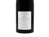 a bottle of wine that is sitting on a table