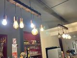 a bar with a bunch of lights hanging from the ceiling
