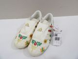 pair of adidas shoes with flowers on them sitting on a white surface