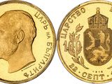 a close up of a gold coin with a crown on it