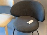 two chairs and a stool in a room with a white background