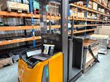 the forklift is parked in the warehouse with a laptop on it