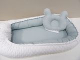 a baby bed with a stuffed animal on top of it