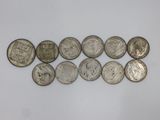 a bunch of silver coins sitting on top of a white surface