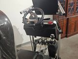 a computer desk with a steering wheel in the middle of the room