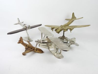 three toy airplanes sitting next to each other on a white surface
