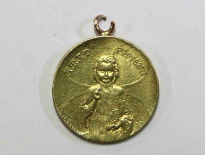 une image représentant une médaille d'or sur laquelle figure le portrait d'un homme