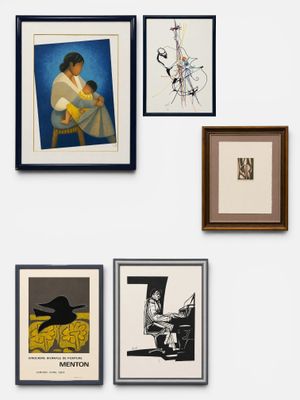 many framed pictures on the wall of this room