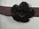a belt with a flower on it on a mannequin mannequin