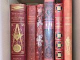 many books that are in a box on the shelf