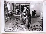 a black and white photo of a man sitting in a chair