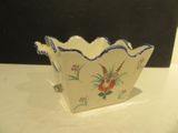a small bowl with a flower design on it on a table