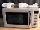 a microwave sitting on top of a wooden table