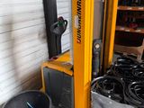 a forklift that is parked next to a pile of tires