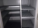 une étagère métallique avec des tablettes, placée au milieu d'une pièce