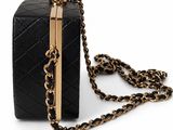 a black quilted purse with a gold chain strap