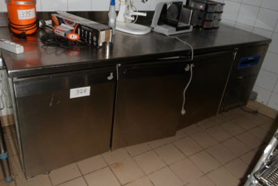 stainless steel counter top in a commercial kitchen with appliances on top of it