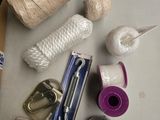 a box of yarn, scissors, scissors, and other items on a table