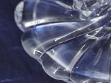a close up of a clear glass bowl on a blue cloth