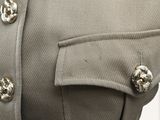 a close up of a jacket with buttons on it