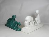 pair of white and green figurines of a man and a woman