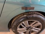 a close up of a car ' s tire with a sticker on it