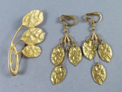 two pairs of gold leaf earrings and a broocher