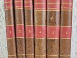 six vieux livres sont alignés sur une étagère
