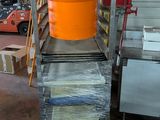 a large orange bucket sitting on top of a metal cart