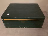 a black box with a yellow lid sitting on the floor