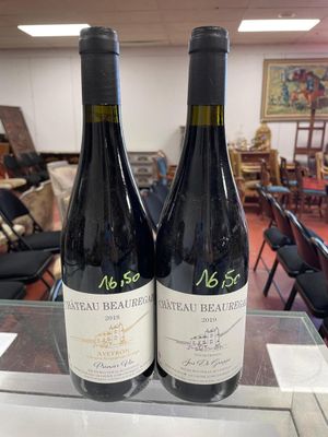 two bottles of wine sitting on a table in a room